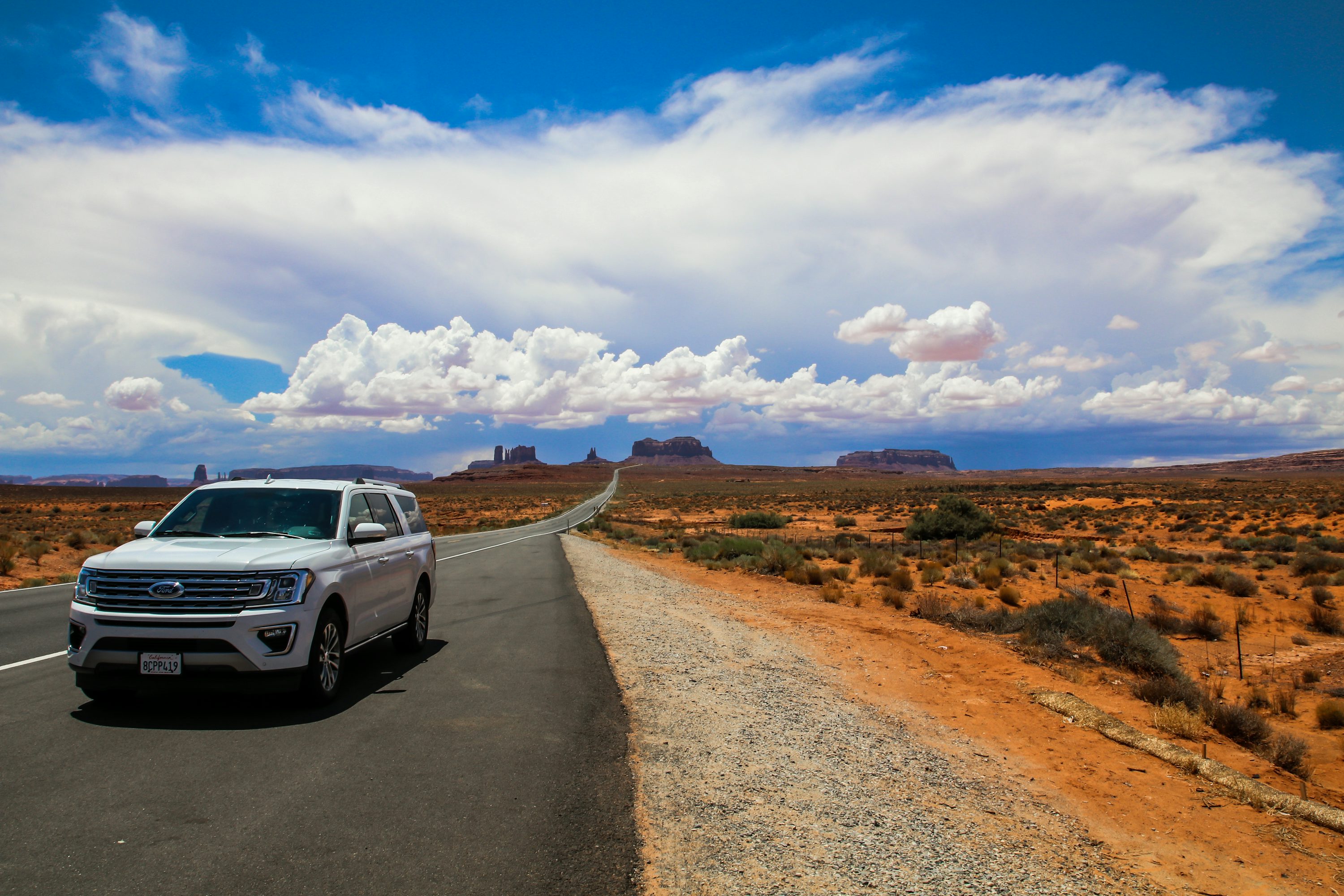 Illustrative SUV on an open desert road